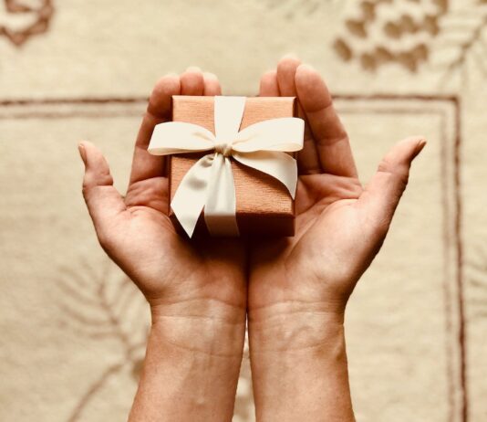 5 Tech-Savvy Valentine’s Day Gift Ideas for the One You Love person s holds brown gift box